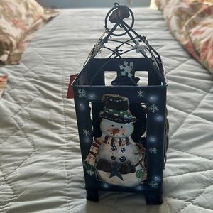 Decorative tin metal winter candle holder.